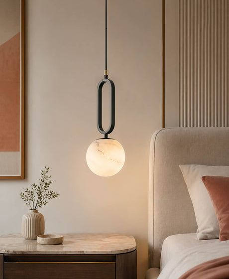 A 15cm ball shape alabaster hanging lights for a bedroom, the pendant light is above the bedside table.