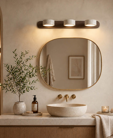 Three heads yellow travertine wall lights are mounted above the bathroom washbasin; the lampshades are made of yellow travertine, whilst the wall-mounted lamp bodies consist of elongated walnut-coloured wooden blocks, and the lamp heads can rotate through 180 degrees.