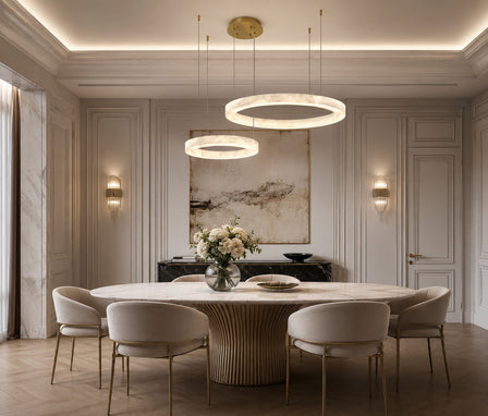 Modern alabaster stone ring pendant light hanging above a dining table.