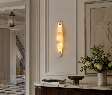 Elegant Spanish alabaster stone wall light illuminating a contemporary entryway.