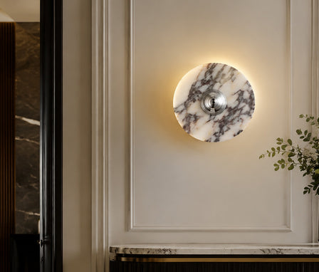 Elegant Calacatta marble wall light mounted on a textured background.