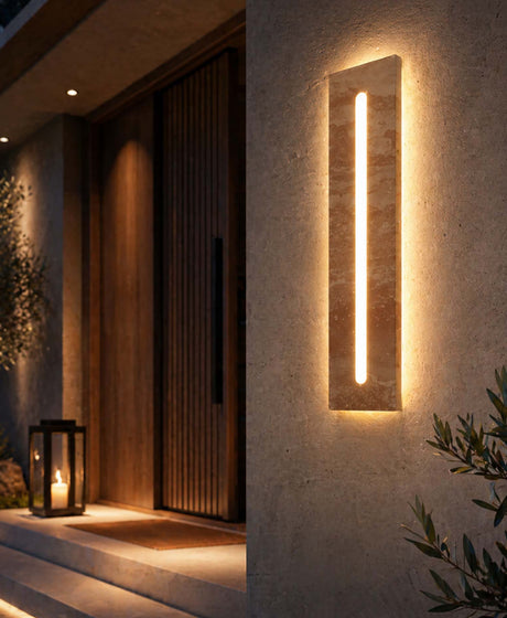 Contemporary outdoor wall lights with a vertical stone LED sconce with ip65 waterfoor illuminating a modern villa entrance with warm ambient lighting.