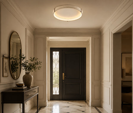 Round natural travertine stone flush ceiling light emitting a warm glow.