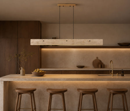 Natural Roman travertine stone pendant light suspended above a modern kitchen island.